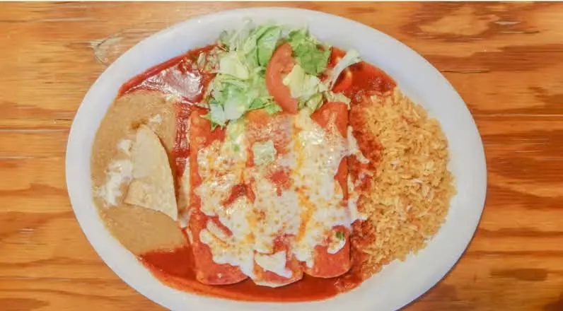 Red enchiladas with rice and beans