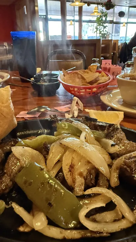 Beef fajitas on a hot skillet